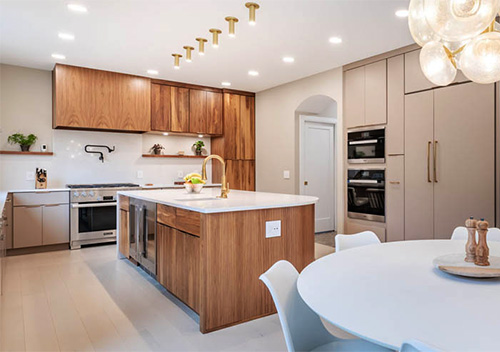 Kitchen with white table, wood-paneled island and wood cabinets set up as part of our full home renovation services near Beacon Hill, Leesburg, VA.