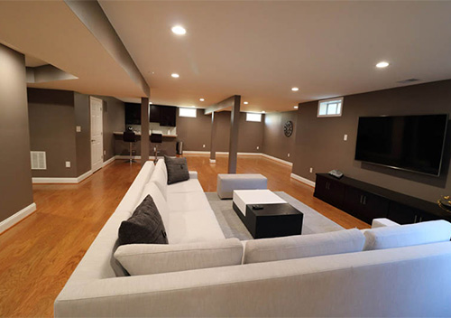 Basement renovation with couches and TV, part of our interior remodeling near Lansdowne on the Potomac, Leesburg, Virginia.