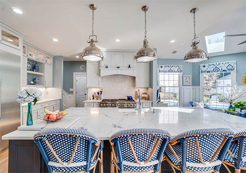 Renovated kitchen with chairs, island, and new cabinets done for kitchen remodeling near Alexandria, Virginia.