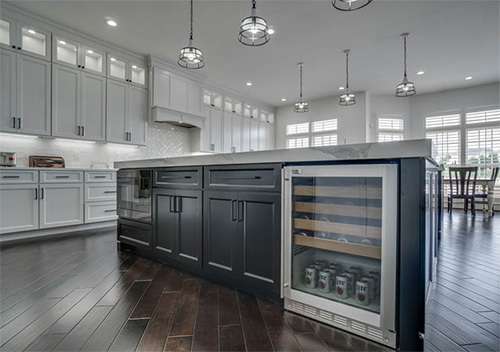 Kitchen island with black cabinets and built-in fridge done as part of our Alexandria kitchen renovation.