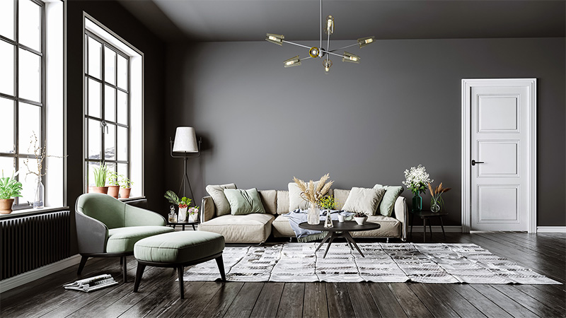 Dark hardwood floor under area rug, couch, and chair, set up by our Fairfax floor installers.