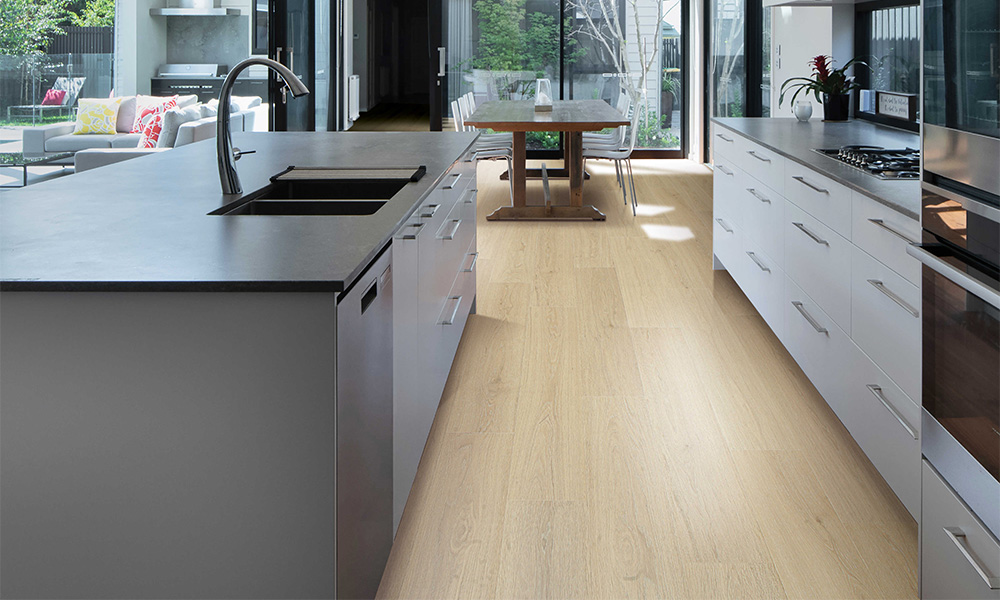 Kitchen and dining area with light brown laminate flooring near Merrifield, Virginia.