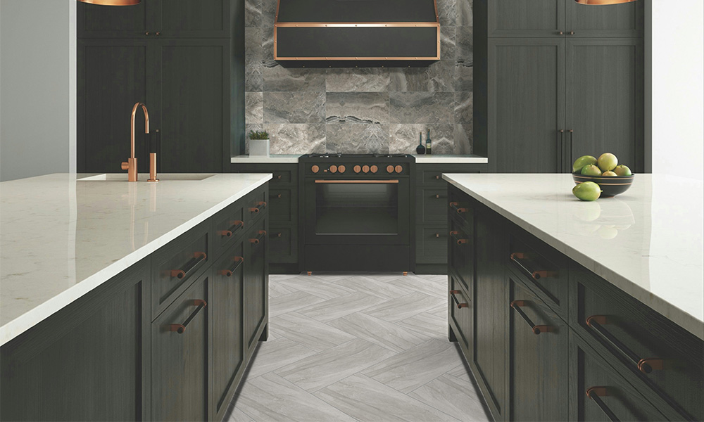 A kitchen with island, countertops, stove, and Aldie porcelain tile floors.