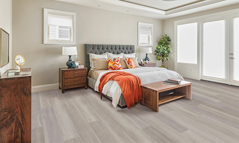 A bedroom with a bed on top of vinyl flooring near Countryside, Sterling, Virginia.